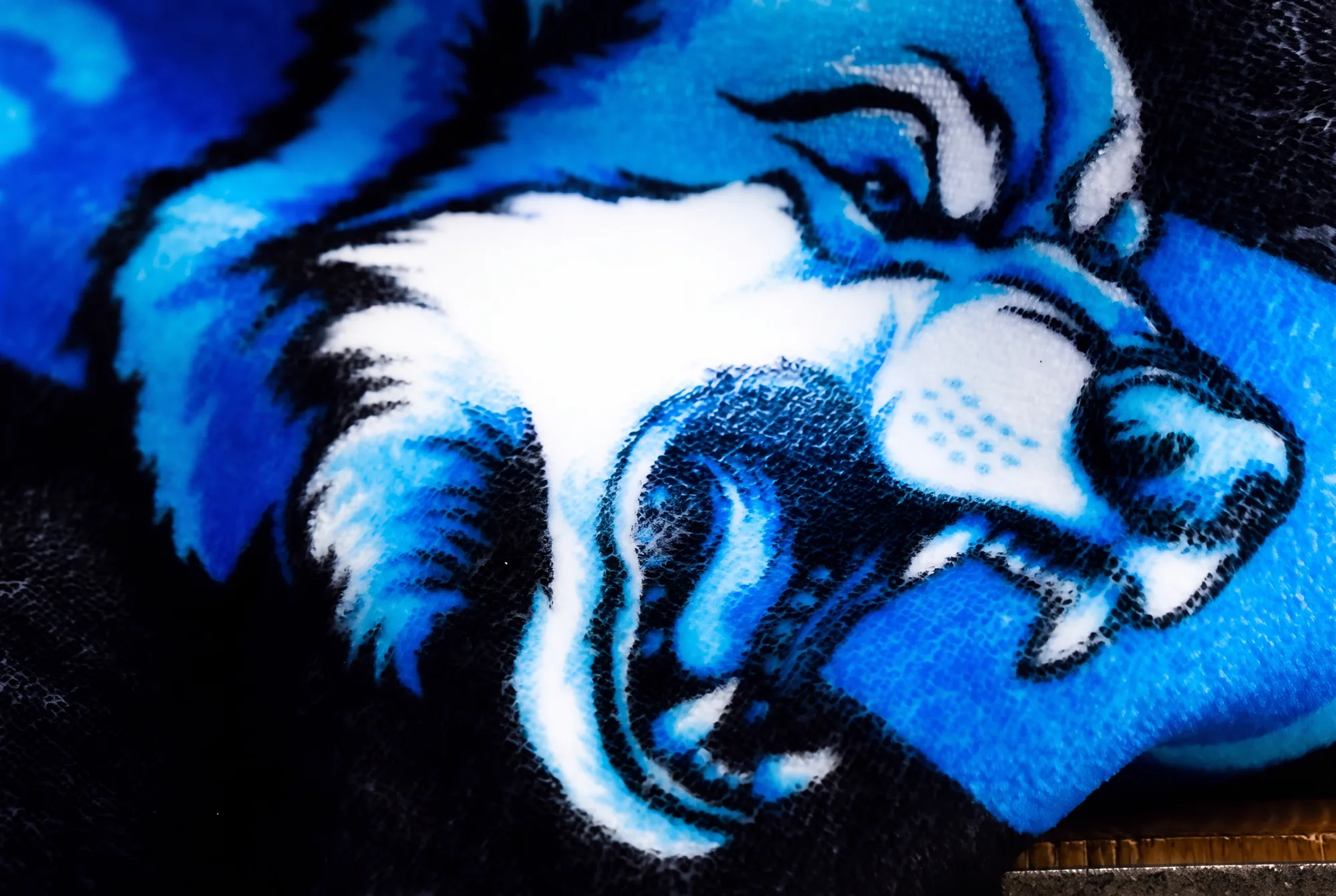 Macro of NubaySoft plush pile carrying a photo-real printed mascot, the ink sitting down in the fibers