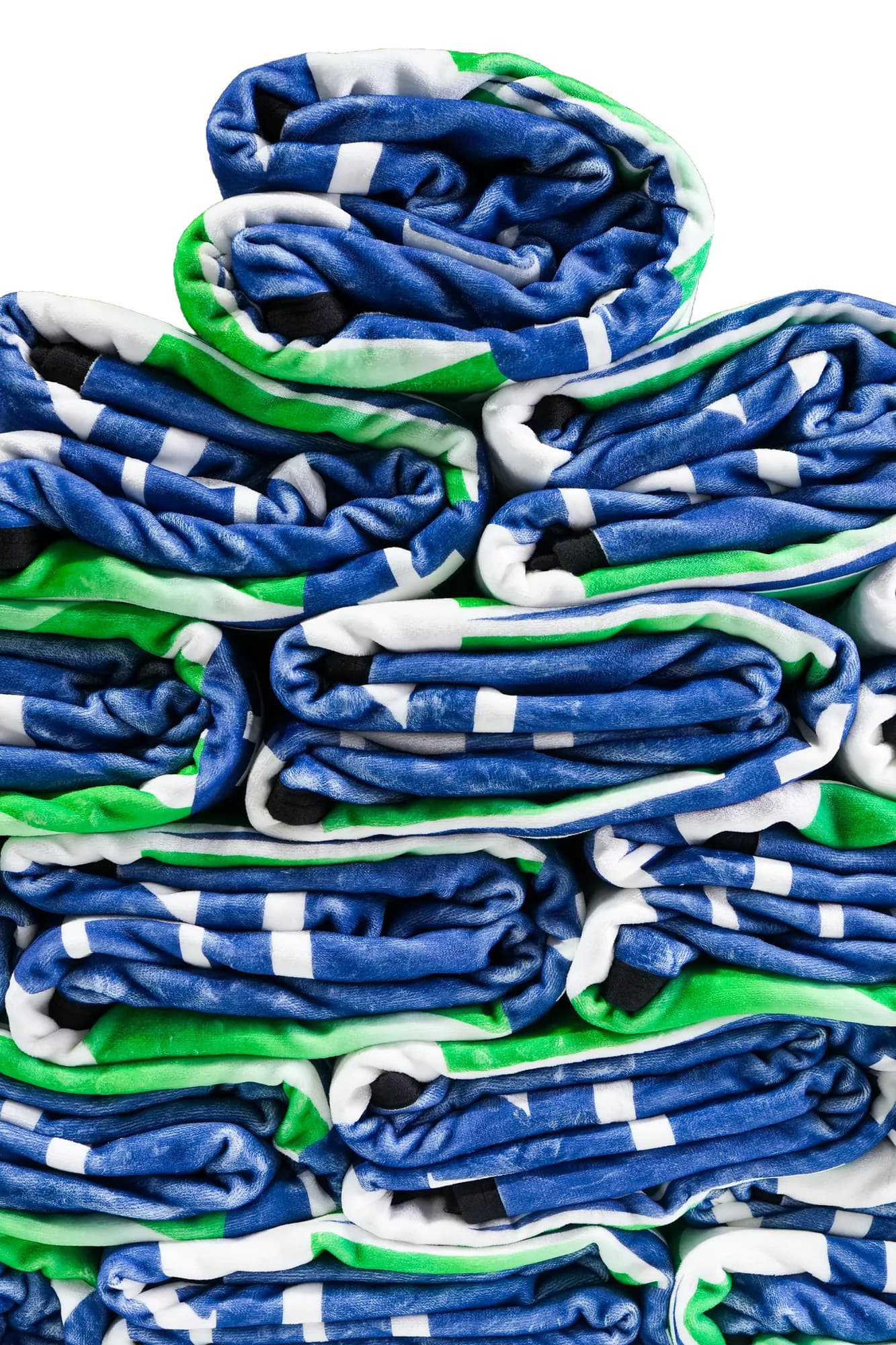 A stack of folded plush blankets, each fold revealing how deep the pile runs